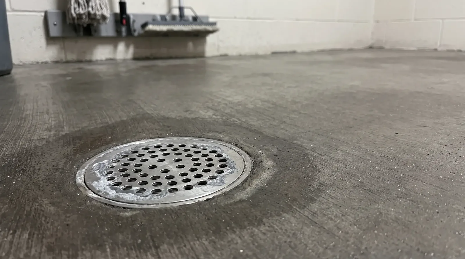 Aged floor drain in a janitorial closet